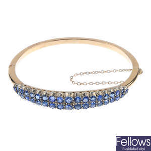 An early 20th century gold sapphire hinged bangle. 