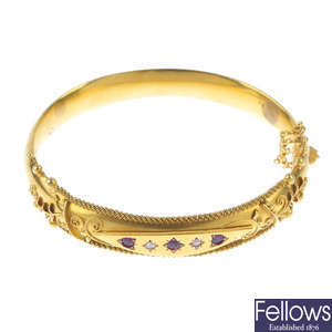 A late Victorian 9ct gold, ruby and diamond hinged bangle.
