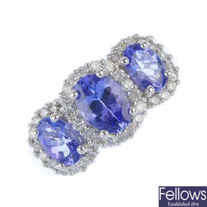 An 18ct gold tanzanite and diamond triple cluster ring.