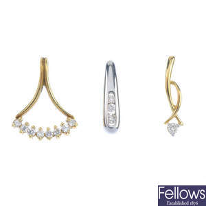 A selection of three diamond pendants and one ear pendant. 