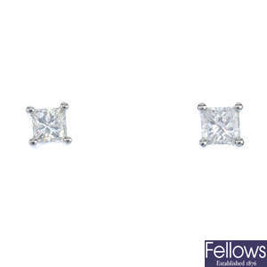 A pair of platinum square-shape diamond ear studs.