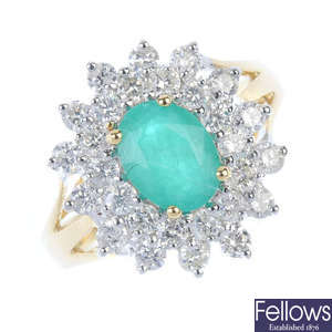 A 9ct gold emerald and diamond cluster ring.