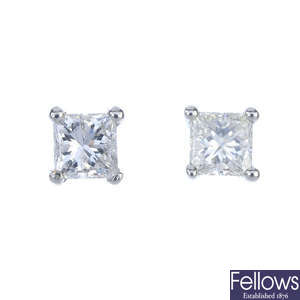 A pair of platinum square-shape diamond ear studs.