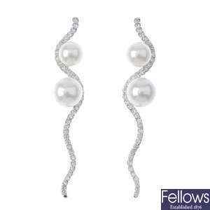 A pair of cultured pearl and diamond ear pendants. 