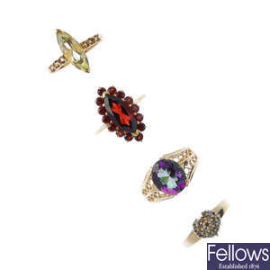 A selection of four 9ct gold gem-set cluster rings.