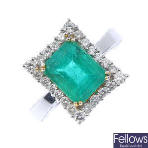 An emerald and diamond cluster ring. 