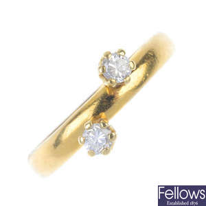 A 22ct gold diamond two-stone ring. 