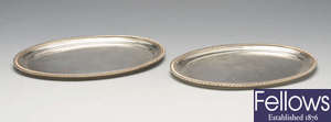 A pair of small silver oval salvers.