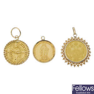 A selection of three coin and token pendants. 
