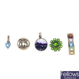 A selection of seven gem-set pendants and a pair of earrings. 