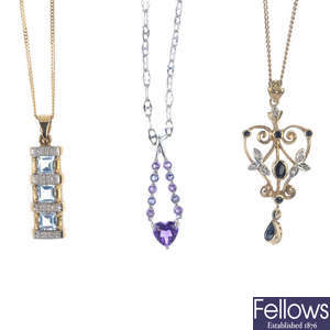 A selection of three gem-set pendants and chains.