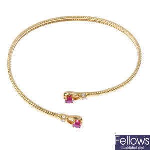 An 18ct gold ruby and diamond flexible cuff. 