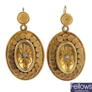 A pair of gold floral ear pendants.