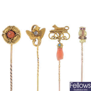 A collection of four gold late 19th to early 20th century stickpins.