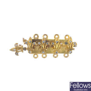A late 19th century gold diamond fleur-de-lys clasp.