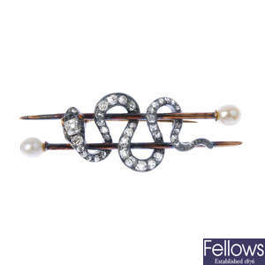 A late 19th century silver and gold diamond and cultured pearl snake brooch.