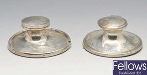 An Edwardian silver Capstan inkwell, plus a similar 1930's example. 