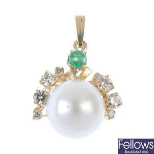 A cultured pearl, emerald and diamond pendant.