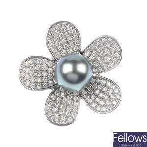 A cultured pearl and diamond flower ring.