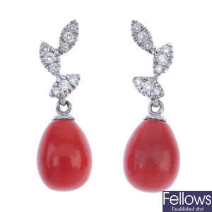 A pair of coral and diamond ear pendants.