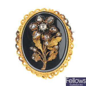 A late Victorian gold onyx and diamond brooch.