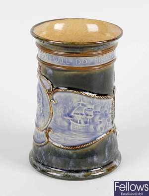 A commemorative Royal Doulton stoneware beaker