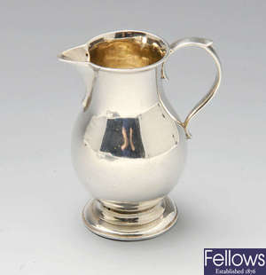 A George II silver sparrow-beak cream jug.