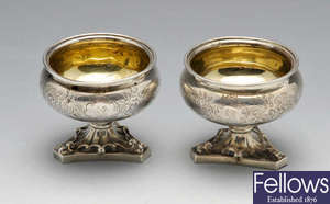 A pair of Victorian silver salts with triangular feet.