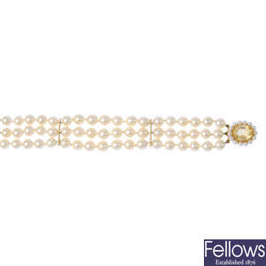 A cultured pearl three-row bracelet, with 9ct gold gem-set clasp.
