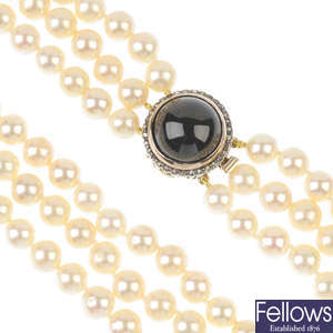 A cultured pearl three-row necklace, with garnet and rose-cut diamond clasp.