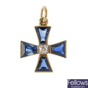 A diamond and sapphire cross pendant.