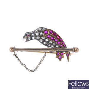 A diamond and ruby parrot brooch.
