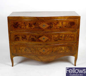 An 18th century Continental inlaid walnut serpentine-fronted chest of three drawers