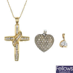 A selection of three gold diamond pendants, with one chain.