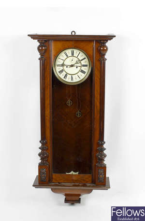 A late 19th century walnut and mahogany cased Vienna style wall clock