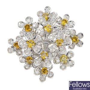 A diamond and colour treated 'yellow' diamond dress ring.