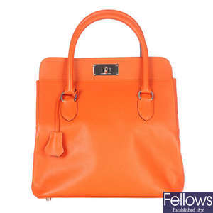 HERMES - an orange leather Toolbox 26 handbag.