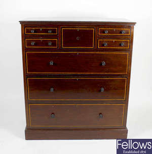 A tall mahogany crossbanded chest of drawers. 