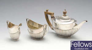 A late Victorian silver three piece bachelor tea set. 