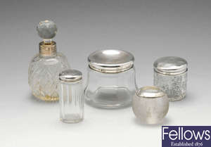 A late Victorian silver mounted cut glass scent bottle, plus four vanity jars. 