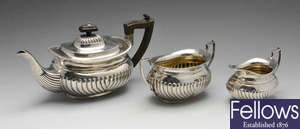 A matched three piece silver tea set.