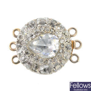 A late 19th century gold and silver diamond cluster clasp.