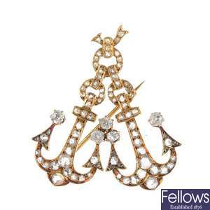 An early 20th century 18ct gold gold diamond double anchor brooch.