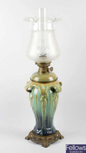 An Art Nouveau porcelain oil lamp. 