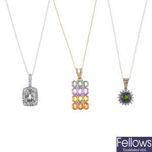 Four gem and diamond set pendants, with chains.