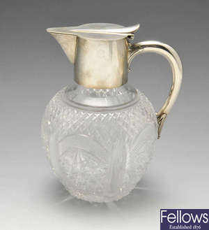 A late Victorian silver mounted cut glass claret jug. 