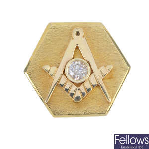 A diamond Masonic tie pin.