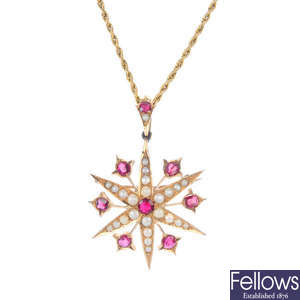 An early 20th century gold garnet and split pearl star pendant.