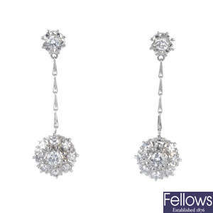 A pair of diamond cluster ear pendants.