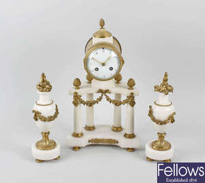 A late 19th century French white marble and gilt metal portico clock set